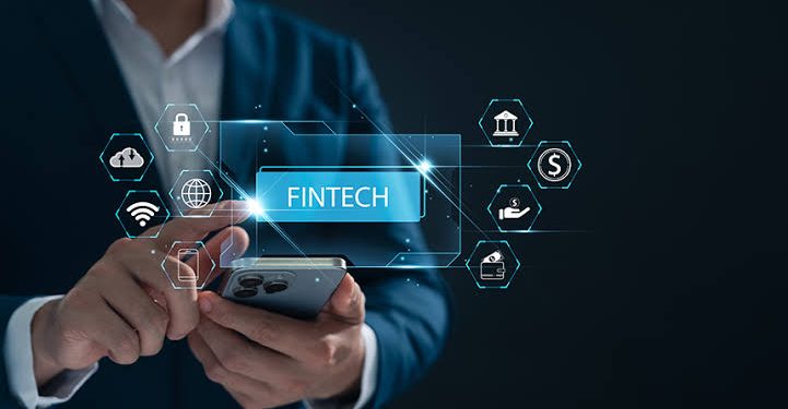 Person in a suit uses a smartphone with glowing fintech icons and a blue 'FINTECH' label