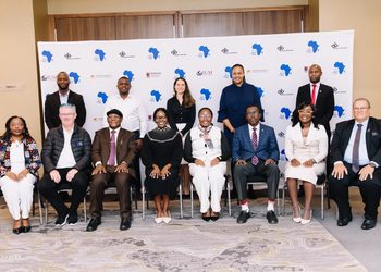 WhatsApp Image 2026-09-22 at 32808 PM - The Brief | Namibia's Leading Business & Financial News Group of 12 professionals in formal attire posing for a conference photo in front of a white backdrop with blue Africa map logos and event branding.