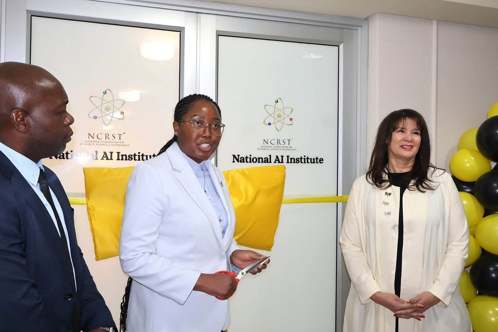 WhatsApp Image 2026-09-24 at 114618 AM - The Brief | Namibia's Leading Business & Financial News Three professionals at a ribbon-cutting ceremony for the National AI Institute, with yellow cushions and balloons nearby.