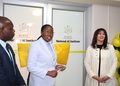 Three professionals at a ribbon-cutting ceremony for the National AI Institute, with yellow cushions and balloons nearby.