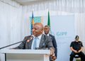 ELIJAH NGURARE8 - The Brief | Namibia's Leading Business & Financial News Public official in a gray suit speaks at a podium with a microphone; flags and a GIPF banner are in the background.