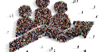 A large crowd of people arranged to form the shape of a computer mouse cursor