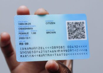 ID - The Brief | Namibia's Leading Business & Financial News Blue citizen ID card being held, featuring a QR code and printed personal details on a light background