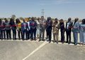 WhatsApp Image 2026-10-09 at 110949 AM - The Brief | Namibia's Leading Business & Financial News Group of officials and community members standing on a highway, cutting a red ribbon to open a new road.