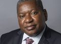 Jerobeam Shaanika - The Brief | Namibia's Leading Business & Financial News Portrait of a middle-aged Black man in a dark suit and patterned tie against a gray background, looking at the camera.