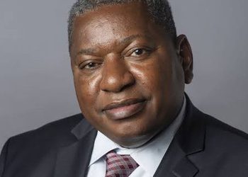 Jerobeam Shaanika - The Brief | Namibia's Leading Business & Financial News Portrait of a middle-aged Black man in a dark suit and patterned tie against a gray background, looking at the camera.