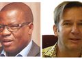 Two head-and-shoulders portraits side by side: left image shows a dark-skinned man wearing glasses and a suit, speaking or mid-sentence against a neutral backdrop; right image shows a light-skinned man with short hair wearing a patterned shirt, smiling softly against a light background.