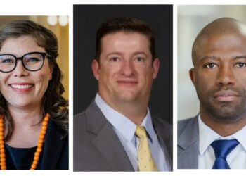 Left: woman with glasses and orange bead necklace; center: man in suit with yellow tie; right: man in gray suit with blue tie.