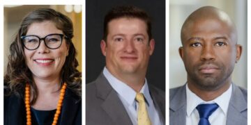 Left: woman with glasses and orange bead necklace; center: man in suit with yellow tie; right: man in gray suit with blue tie.